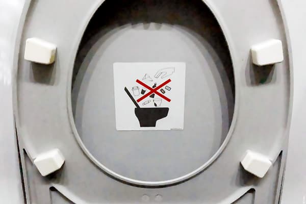 Klistermärke som förbjuder att kasta sopor i toaletten